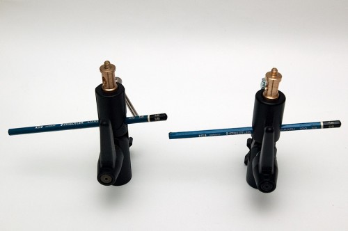 Illustrating using a pencil instead of diffuser umbrella. Meking Type H (Left) and Manfrotto 026 (Right). Illustrating that both adapters' umbrella holder hole are angled.